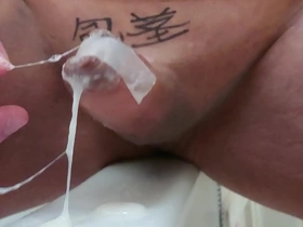 Japanese gay masturbation with uncut cock in a tape cage